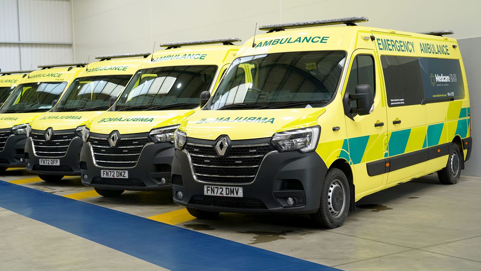 A fleet of ambulances inside the building.