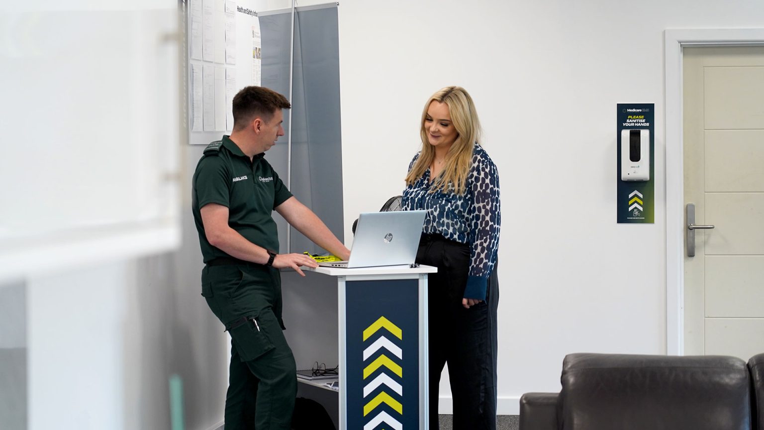ambulance staff showing pupil computer