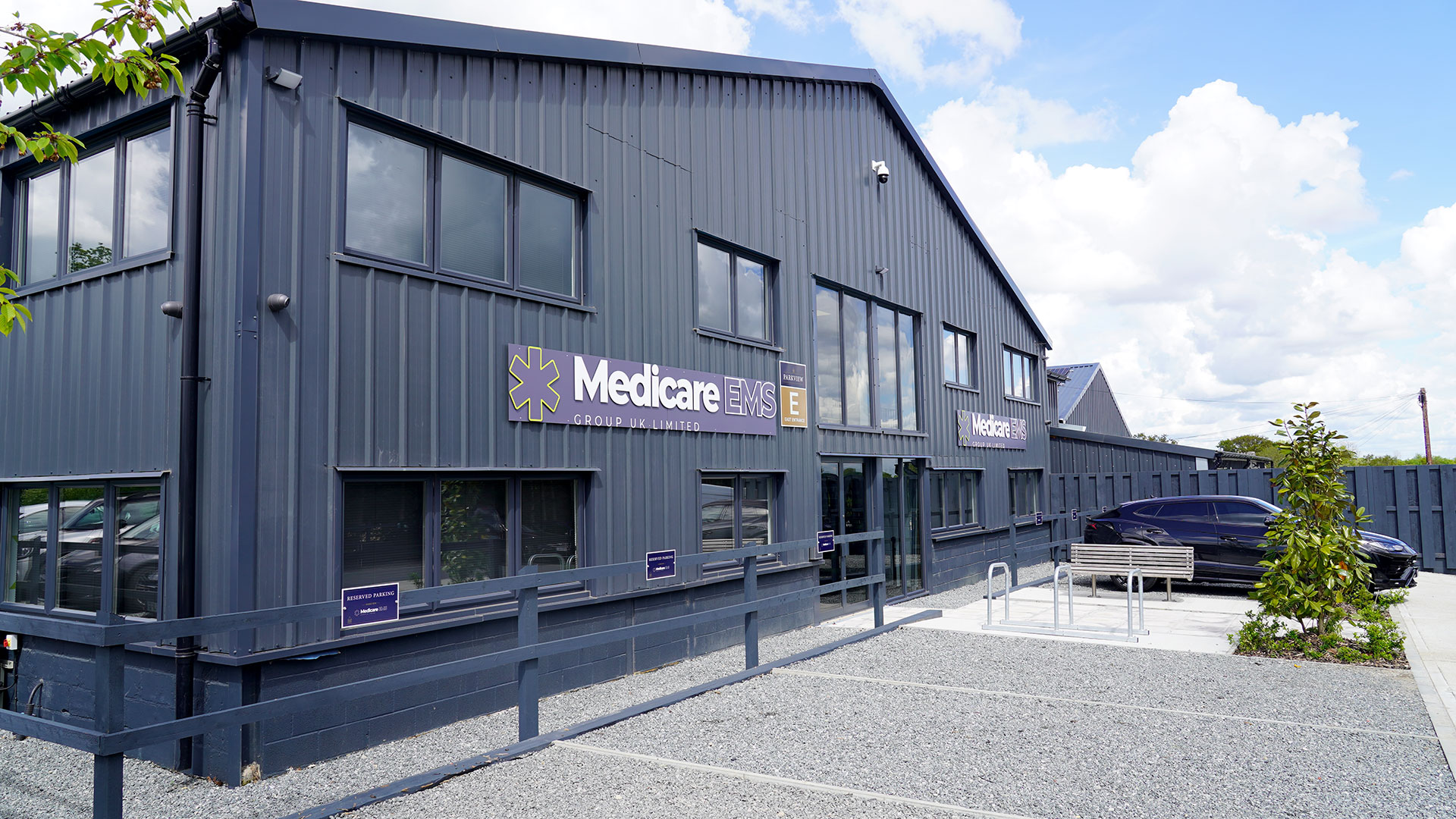 Medicare EMS logo on the front of a building. The building is a navy blue/purple colour.